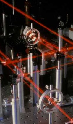 Red laser light beamed and reflected through mechanical parts