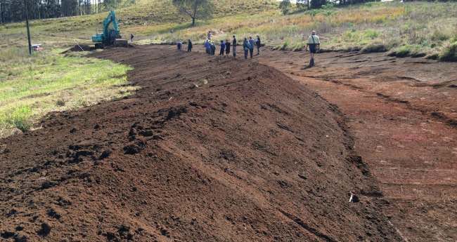 Permaculture activist change developing land with digging an upper swale on a property for long term water management