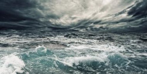 Wind circling over ocean surface creating surface disturbances - iStockPhoto