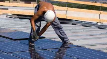 Solar Panels Being Assembled in Array on Roof - iStockPhoto